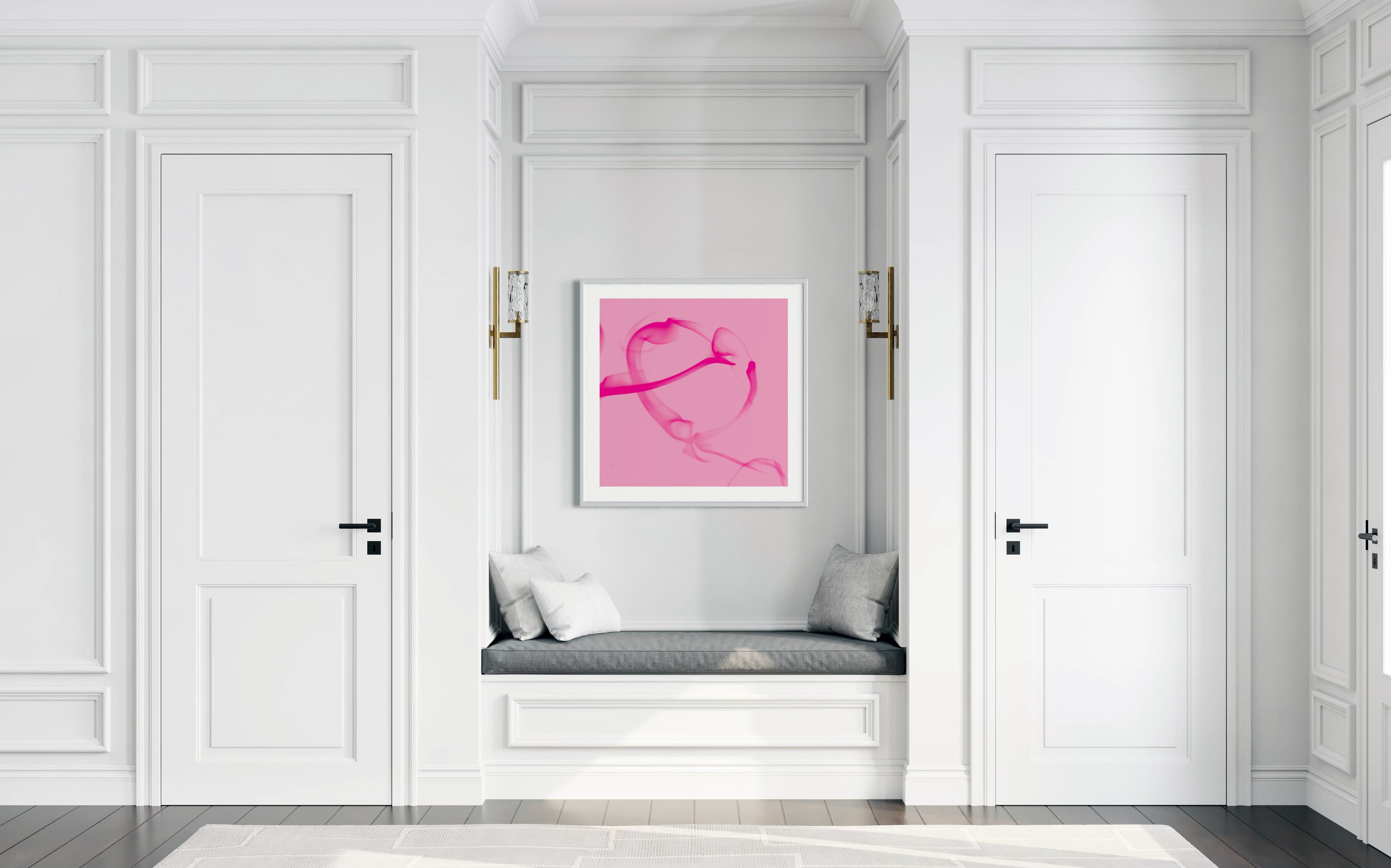 Modern interior with a pink abstract artwork on a white wall.