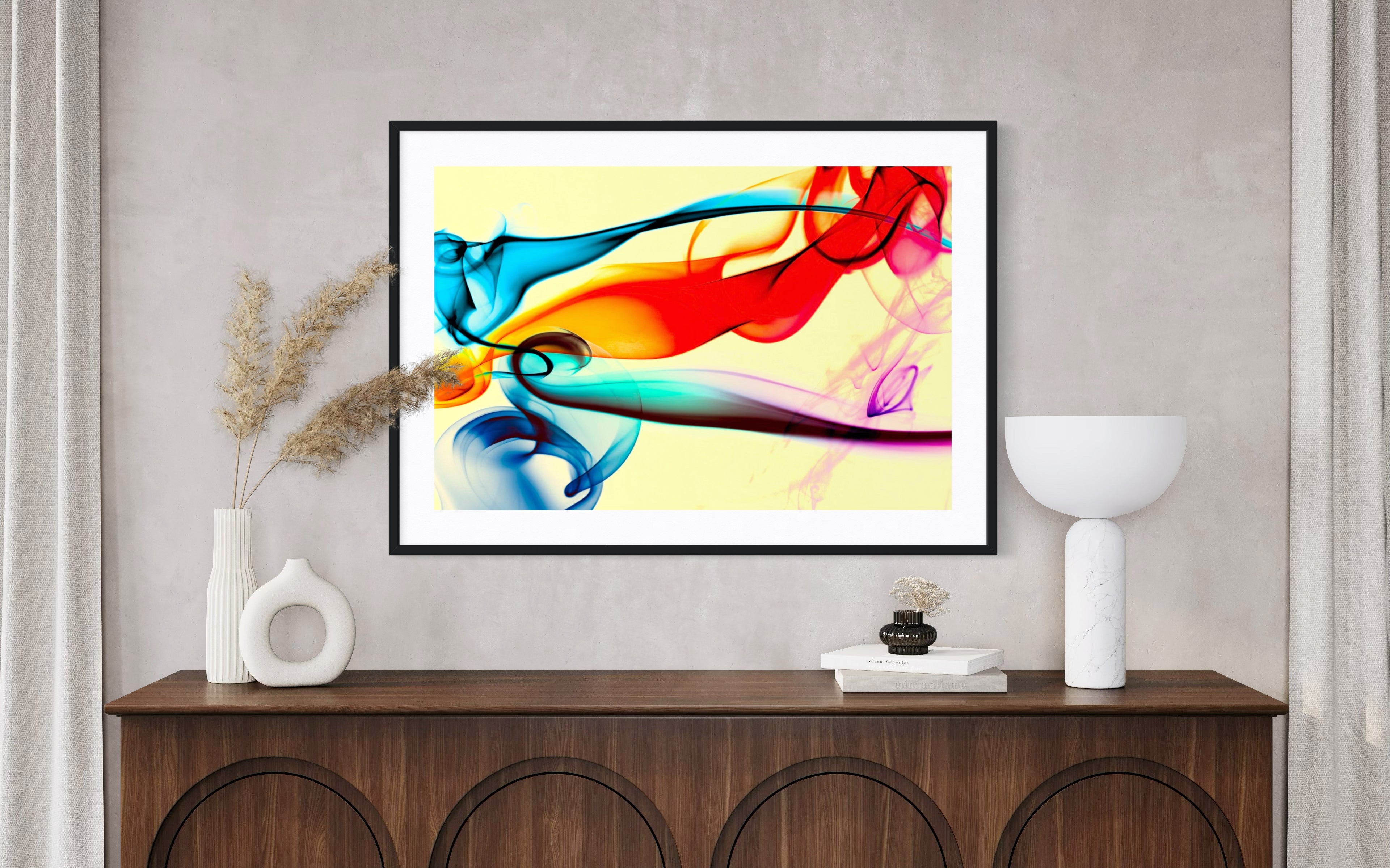 Colorful abstract painting on a wall above a wooden console table with decorative items.
