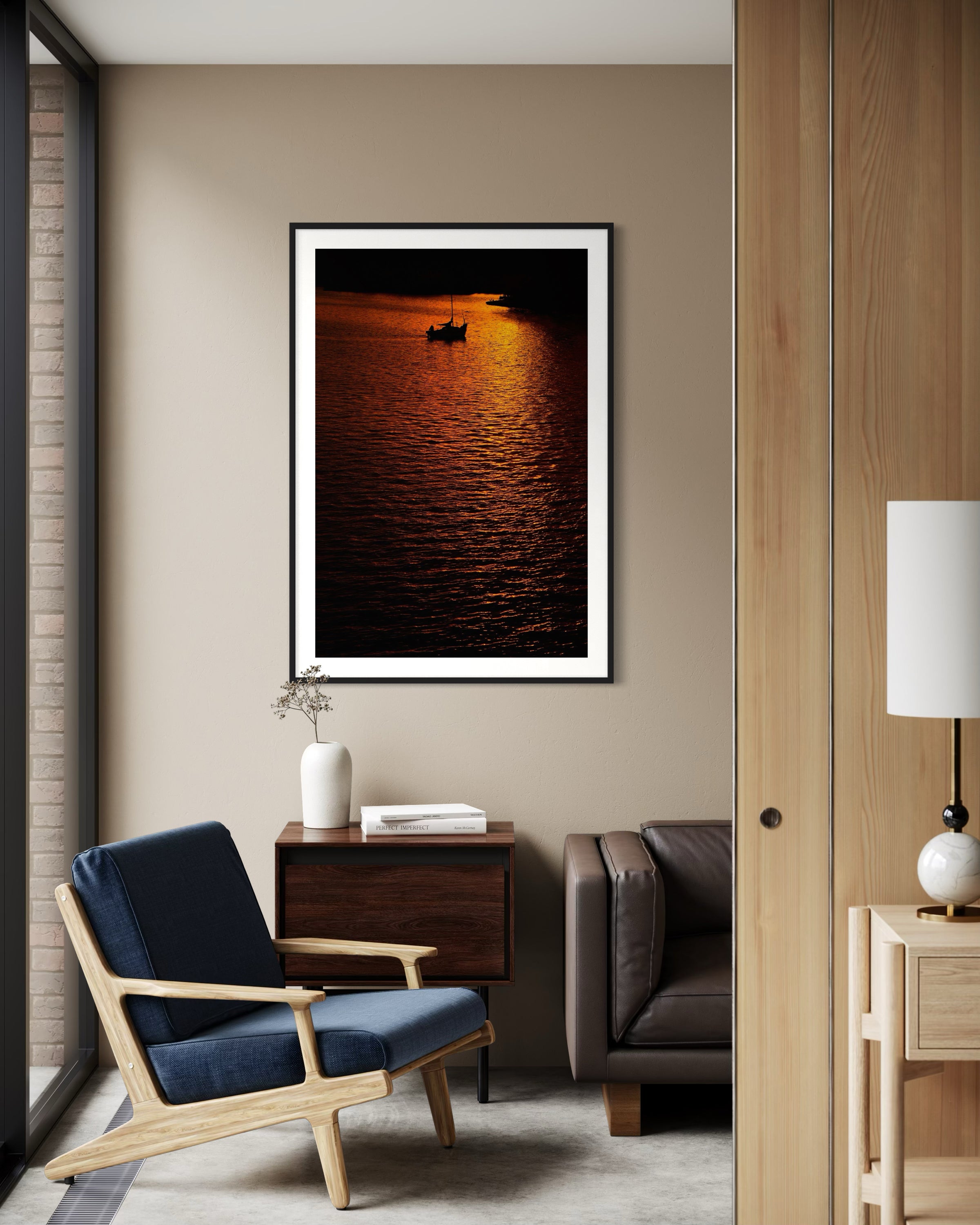 Framed artwork of a sunset over water in a modern living room.