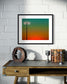 photo of stadium light at sunset in black frame on white brick wall above small small table