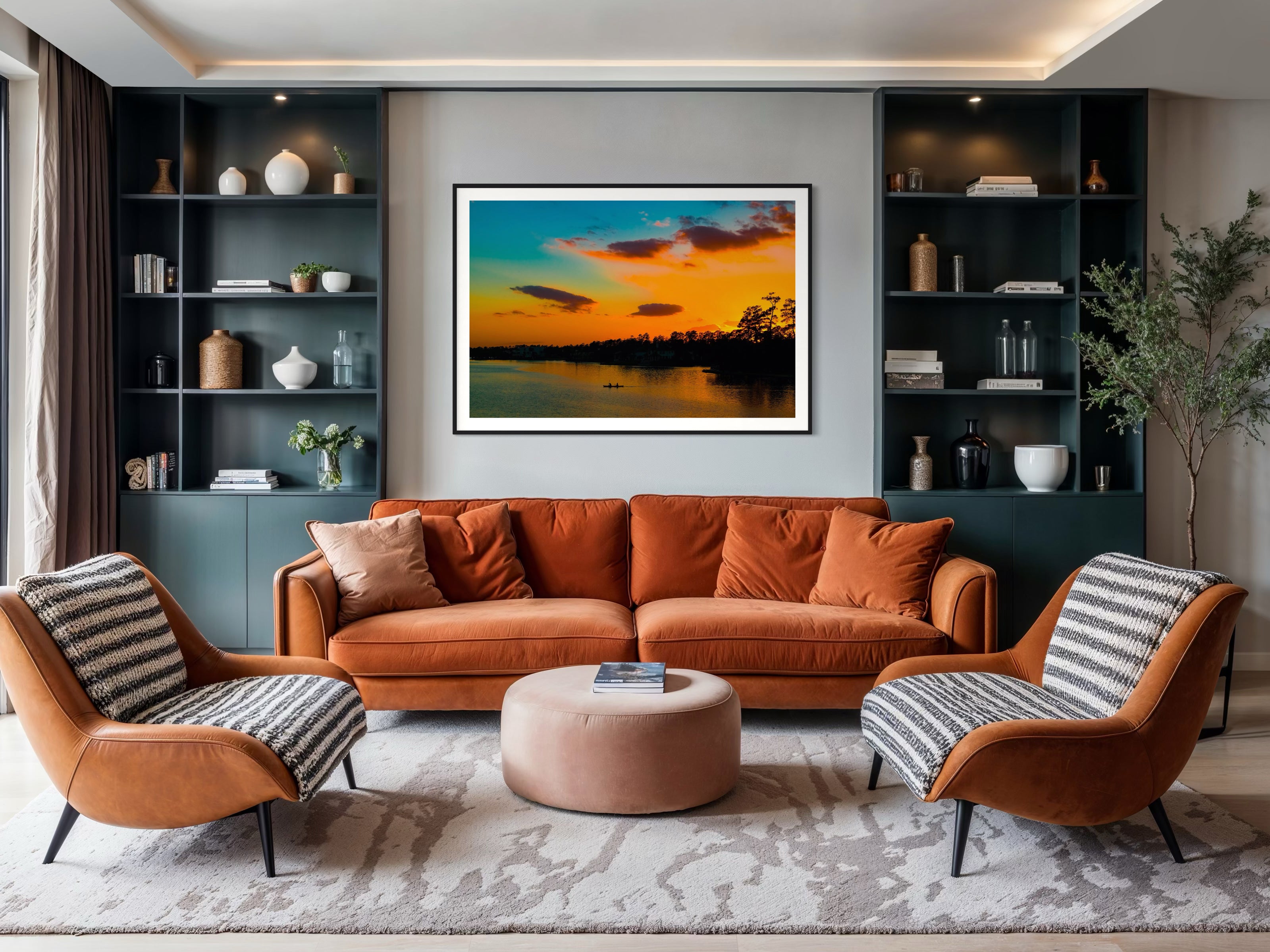 Modern living room with orange sofa, striped armchairs, and a sunset painting on the wall.