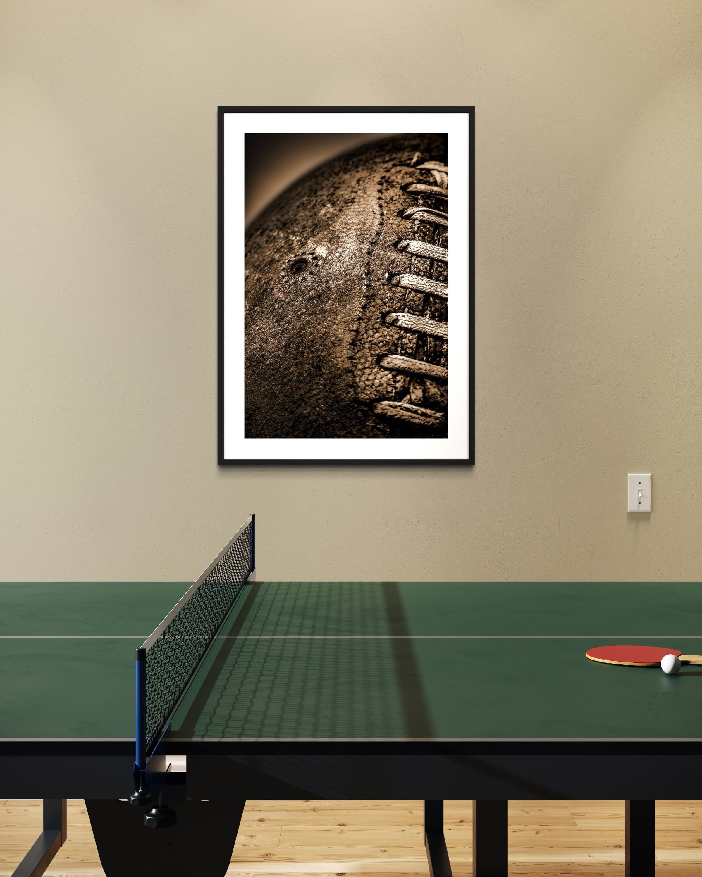 Framed photograph on a wall above a ping pong table