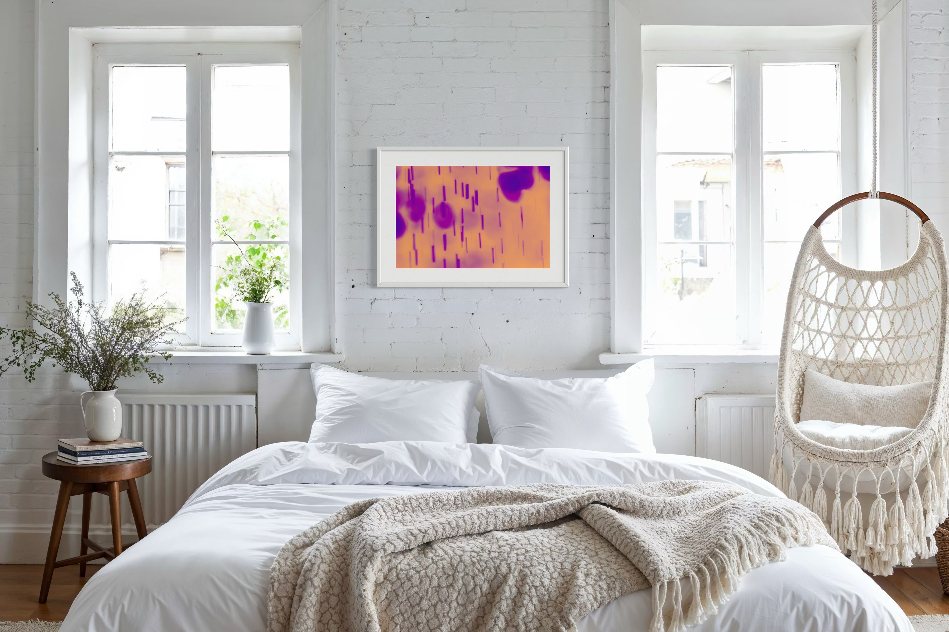 blurred rain in purple on pale yellow background in white frame with white matte on white painted brick wall in relaxed style bedroom with white and tan colors and light hardwood floors