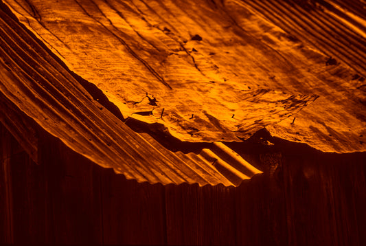 rusty old metal roof on old barn with warm tones photo