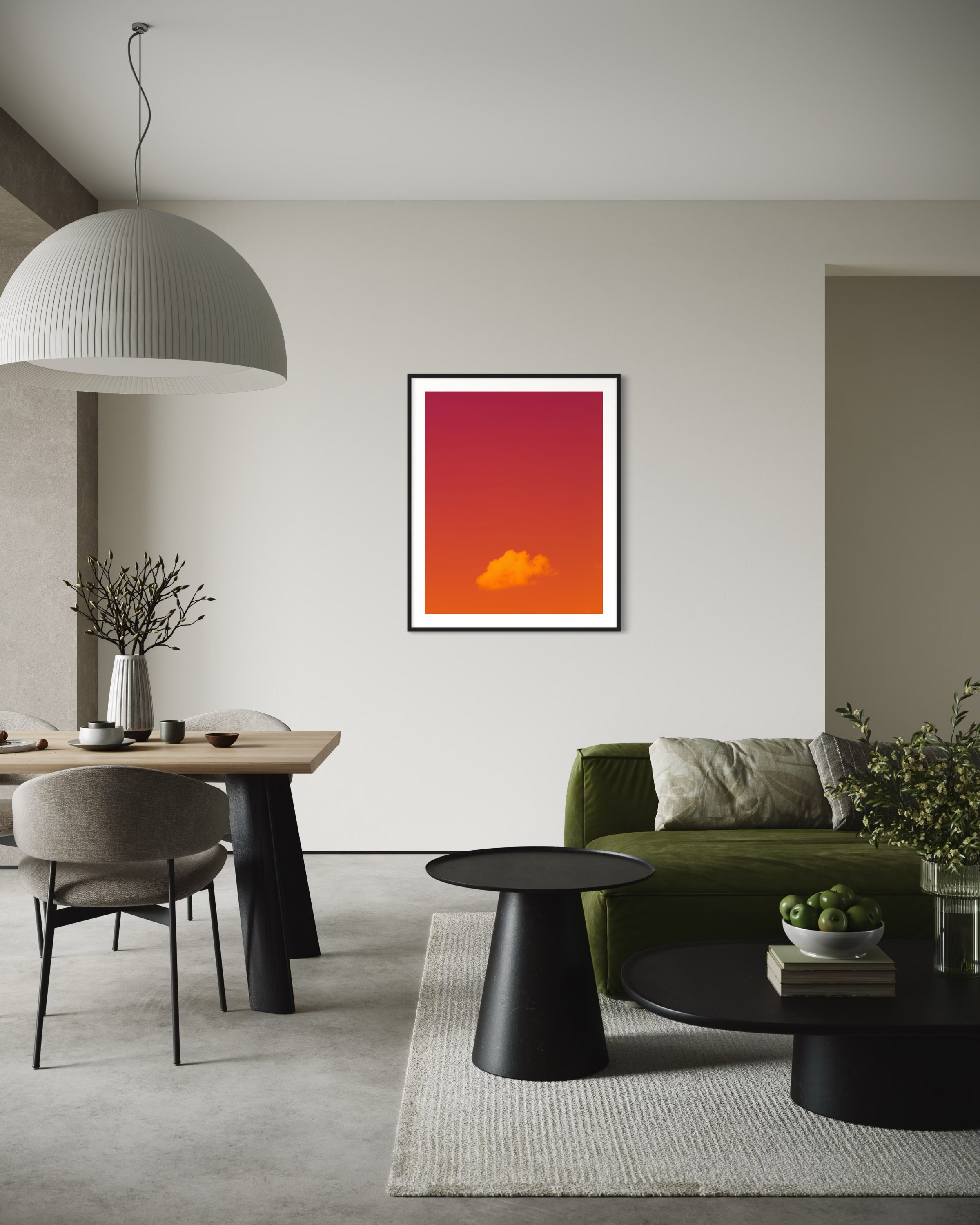 warm tone photo of single cloud in black frame with white matte on white wall above in modern living room withe olive couch and black coffee and end table