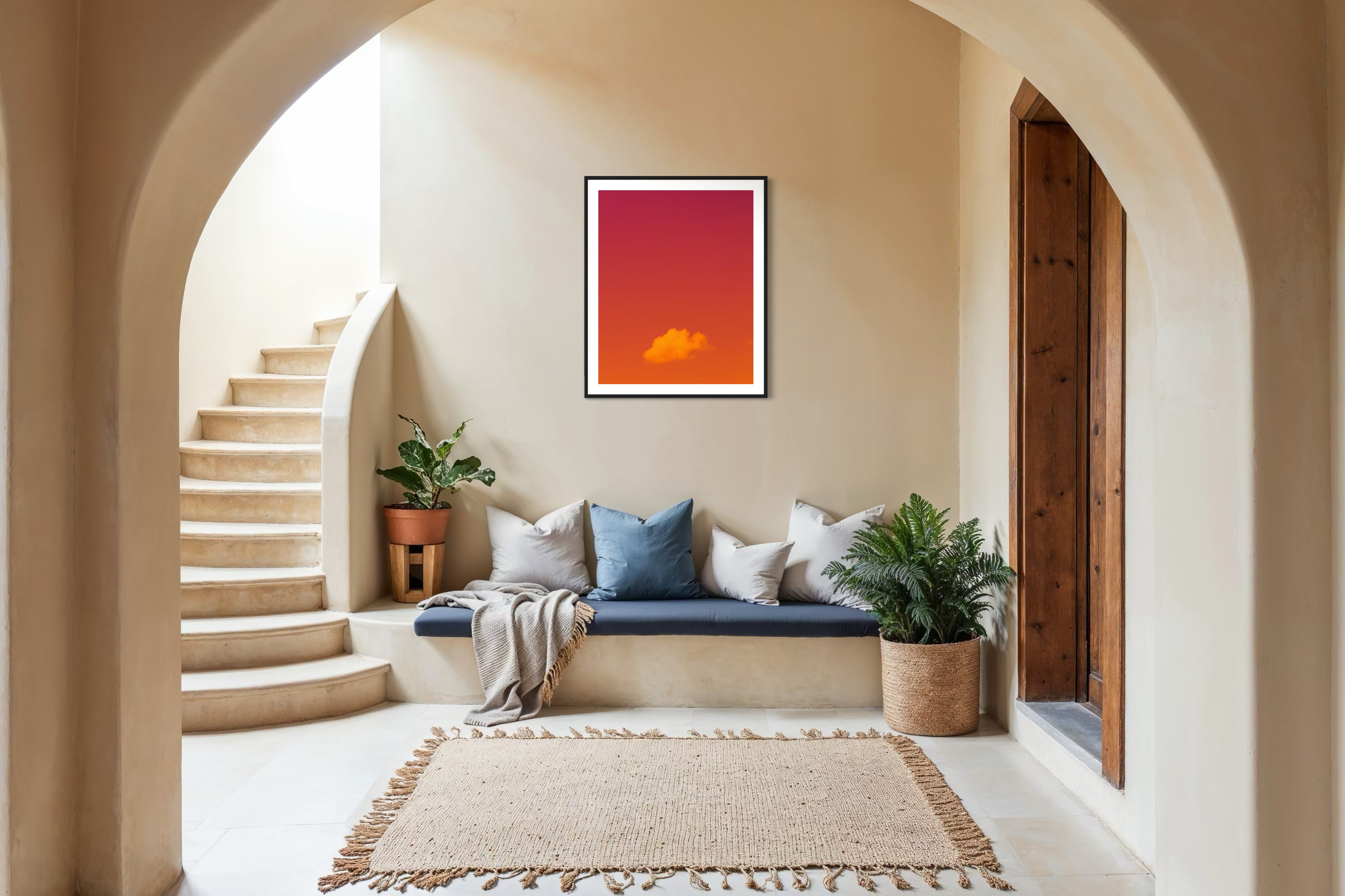 warm tone photo of single cloud in black frame with white matte on tan wall in mediterranean style sitting area