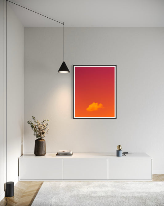 warm tone photo of single cloud in black frame with white matte on white wall in office area in minimalist home with white tones and light colored hardwood floors 