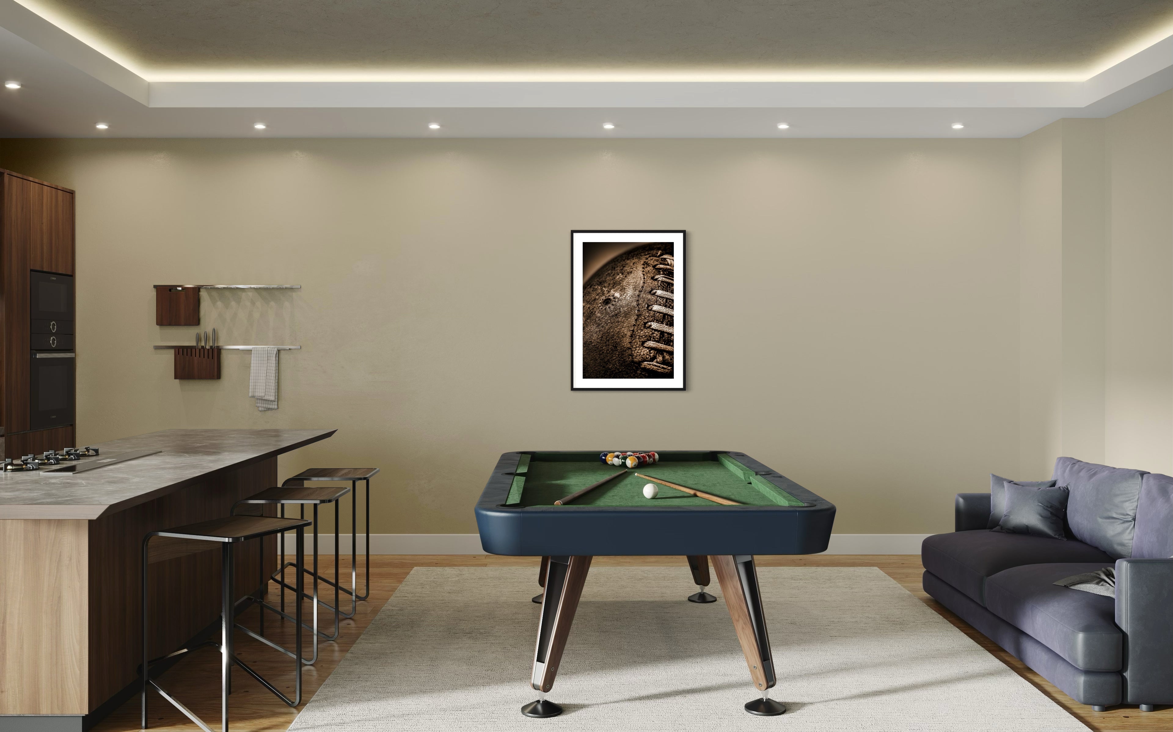 Sepia tone old football close up in a grungy look shot in studio in black frame with white matte on tan wall in game room with green pool table, gray couch and a bar