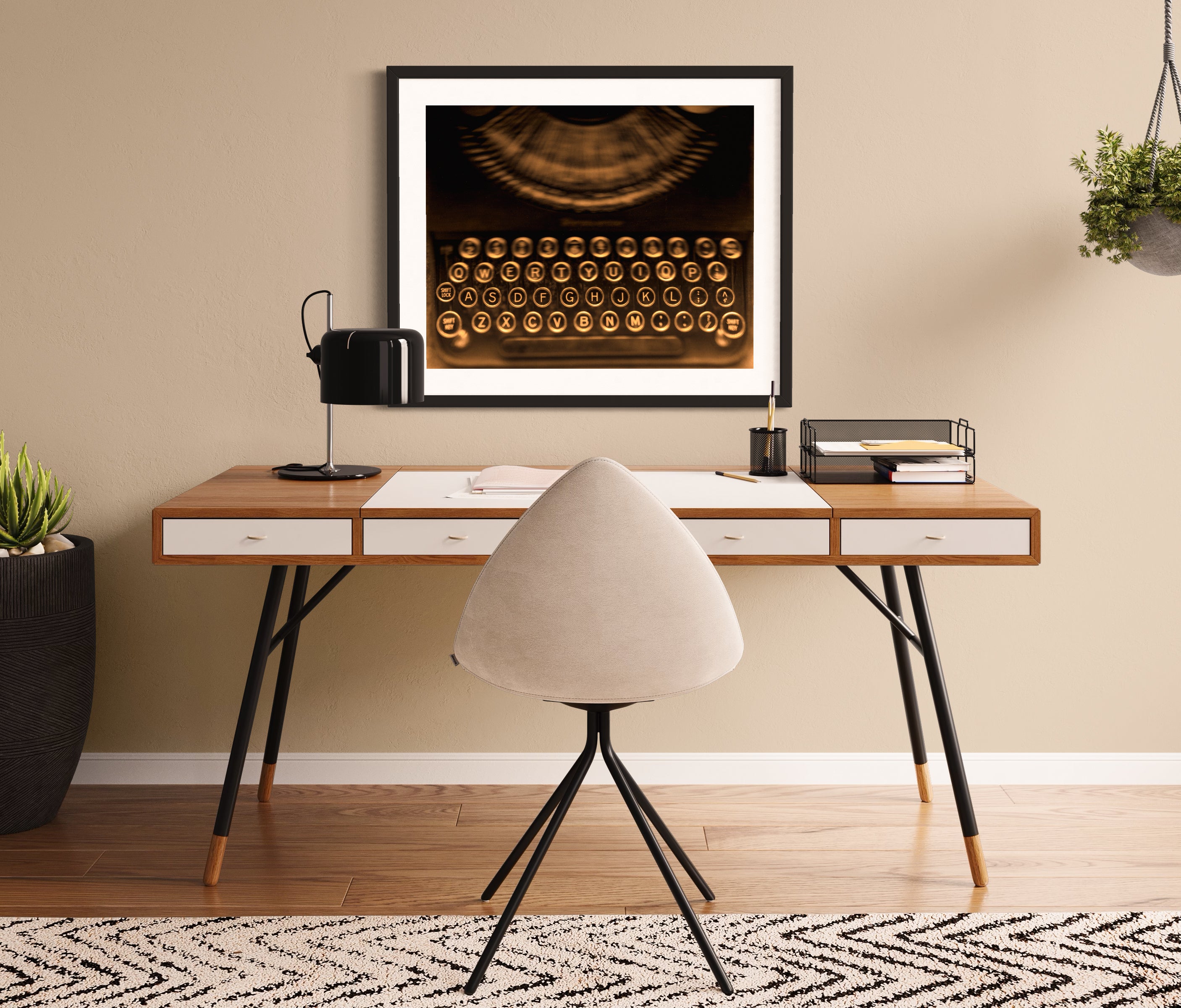 close up of old typewriter from above, horizontal black and white photo in black frame with white matte on wall above modern desk